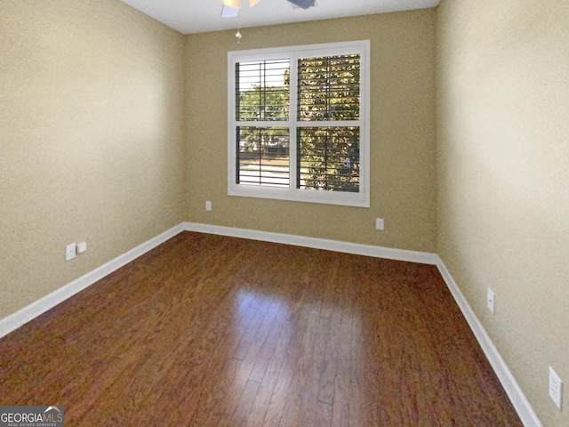 unfurnished room featuring a ceiling fan, baseboards, and wood finished floors