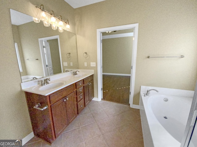 bathroom featuring double vanity, a garden tub, a sink, and tile patterned floors