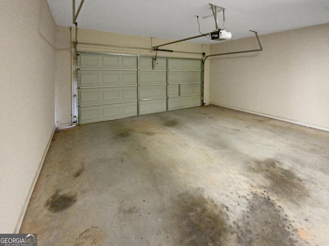 garage featuring baseboards and a garage door opener