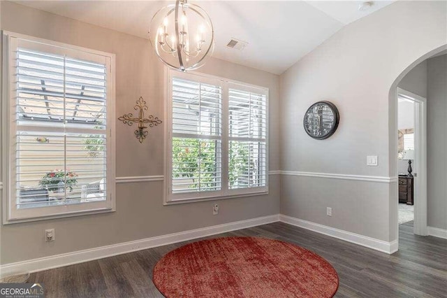 dining area featuring vaulted ceiling, a chandelier, and dark hardwood / wood-style flooring