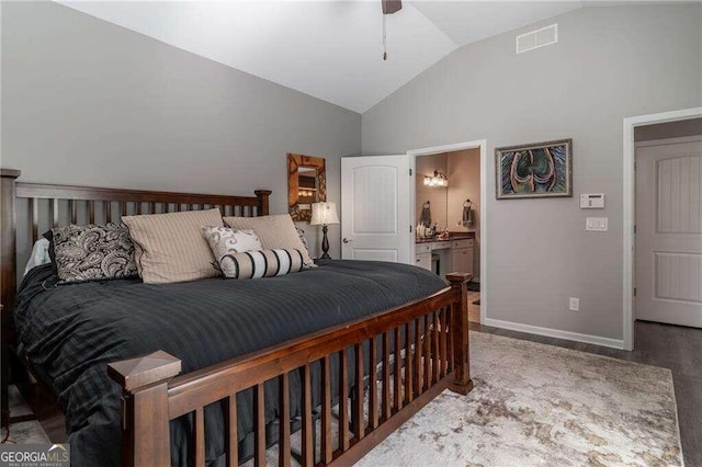 bedroom with ceiling fan, vaulted ceiling, connected bathroom, and wood-type flooring