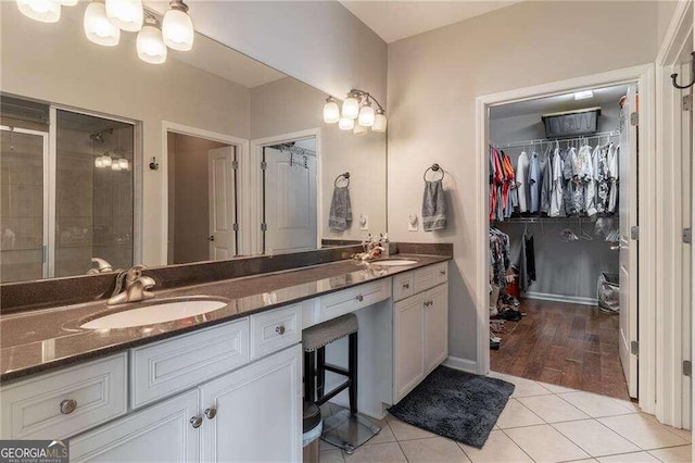 bathroom with vanity, walk in shower, and tile patterned floors