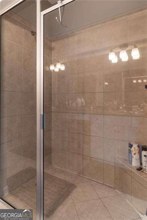 bathroom featuring a shower with shower door