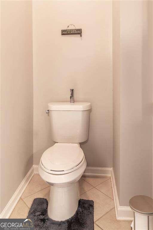 bathroom featuring toilet and tile patterned flooring