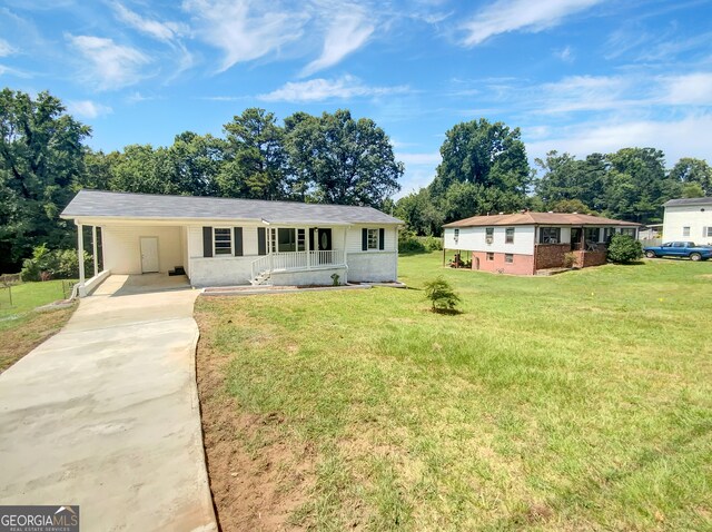 single story home featuring a front yard and a carport