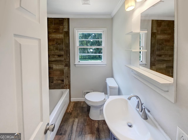 full bathroom with toilet, wood finished floors, a sink, visible vents, and crown molding