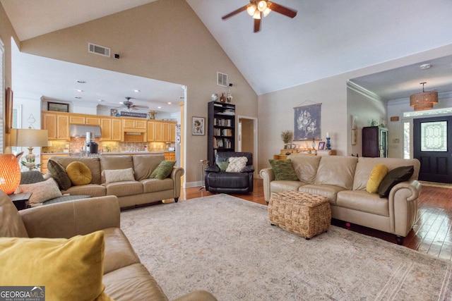 living room with ceiling fan, high vaulted ceiling, and hardwood / wood-style flooring