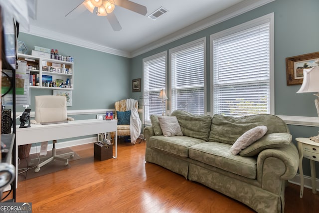 office area featuring crown molding, a healthy amount of sunlight, ceiling fan, and wood-type flooring