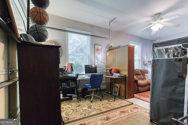 office area with light colored carpet, a wealth of natural light, and ceiling fan