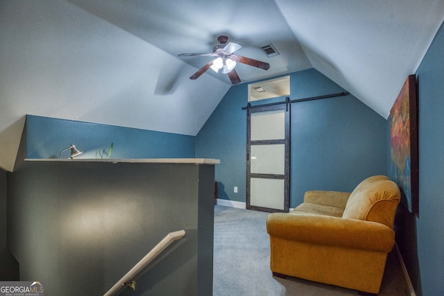 sitting room with ceiling fan, carpet, and vaulted ceiling