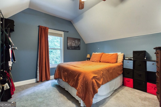 bedroom featuring lofted ceiling, ceiling fan, and carpet