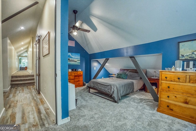 bedroom with lofted ceiling, wood-type flooring, and ceiling fan