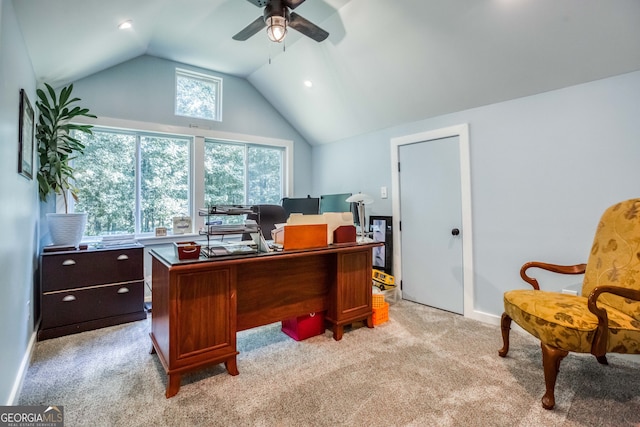 carpeted office space featuring ceiling fan, plenty of natural light, and vaulted ceiling