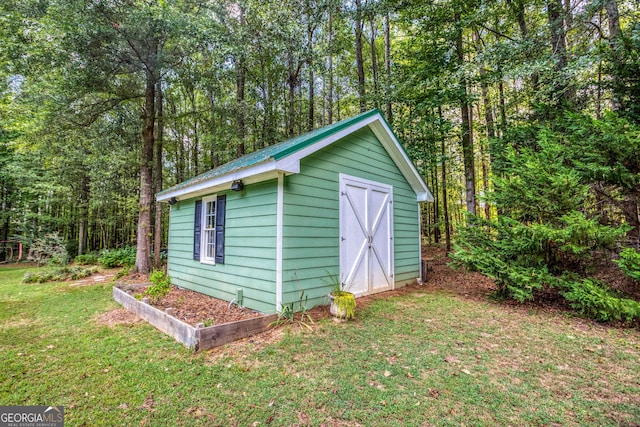 view of outbuilding featuring a yard