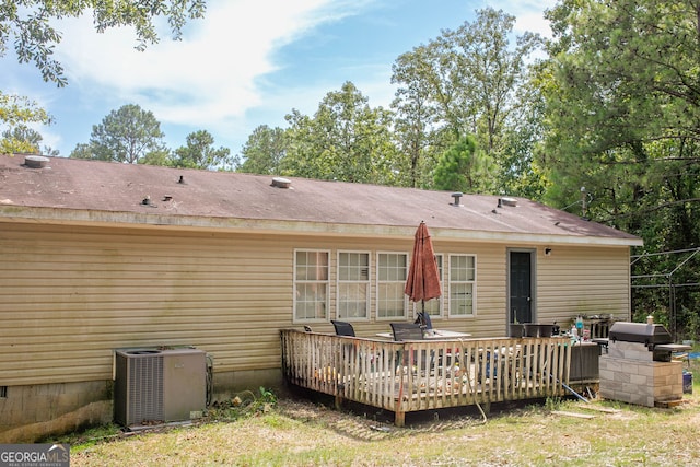 back of property with a wooden deck and central AC unit