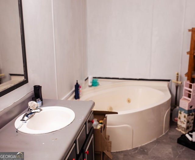 bathroom featuring a tub to relax in and vanity