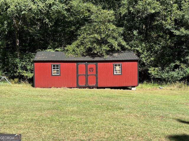 view of outdoor structure with a lawn