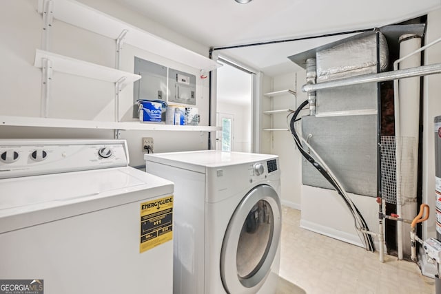 laundry room featuring laundry area, separate washer and dryer, and light floors