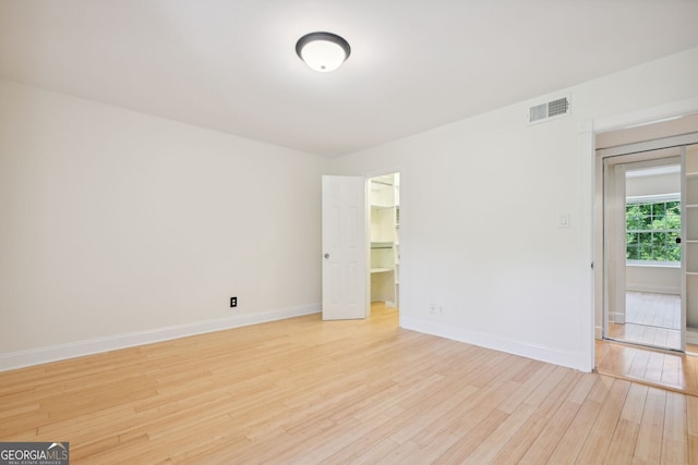 empty room with light hardwood / wood-style flooring