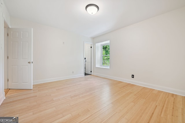 unfurnished room featuring light wood-style floors and baseboards