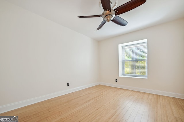 unfurnished room with baseboards, a ceiling fan, and light wood-style floors