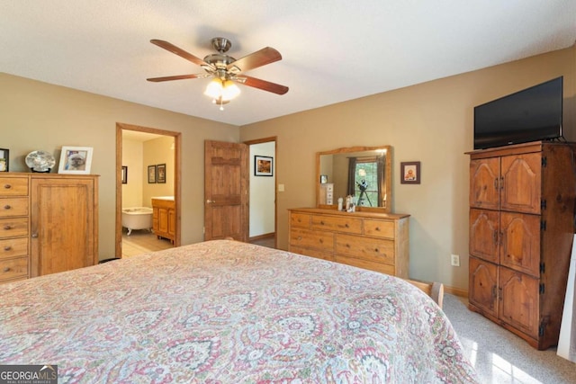 carpeted bedroom with connected bathroom and ceiling fan