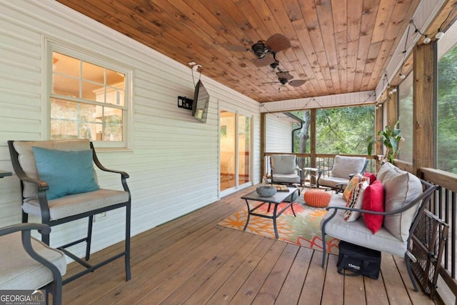 sunroom featuring wood ceiling, ceiling fan, and a wealth of natural light