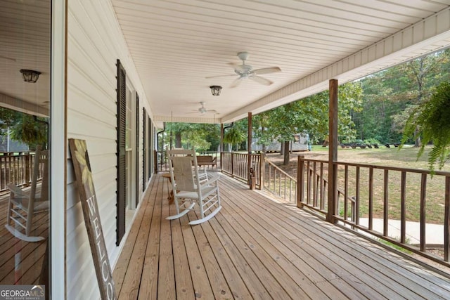 wooden deck with a porch and ceiling fan