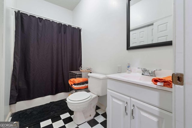 bathroom with vanity, curtained shower, and toilet