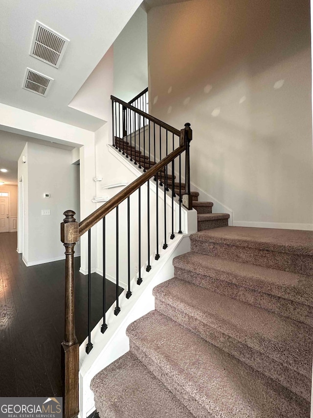 stairway featuring hardwood / wood-style flooring