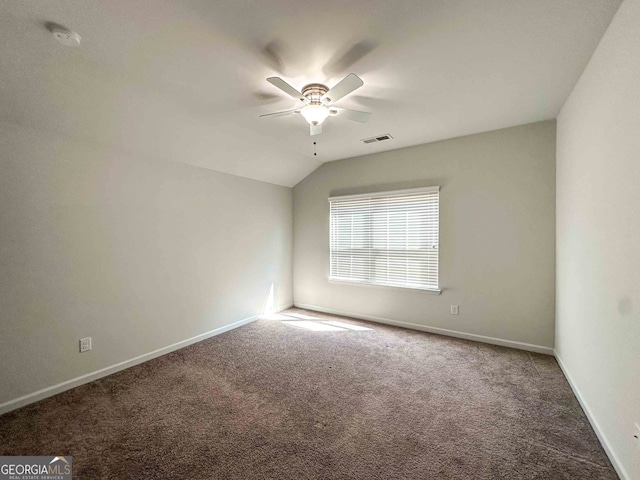 spare room with lofted ceiling, ceiling fan, and carpet floors