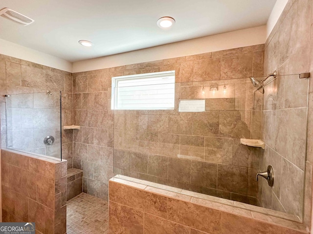 bathroom with a tile shower