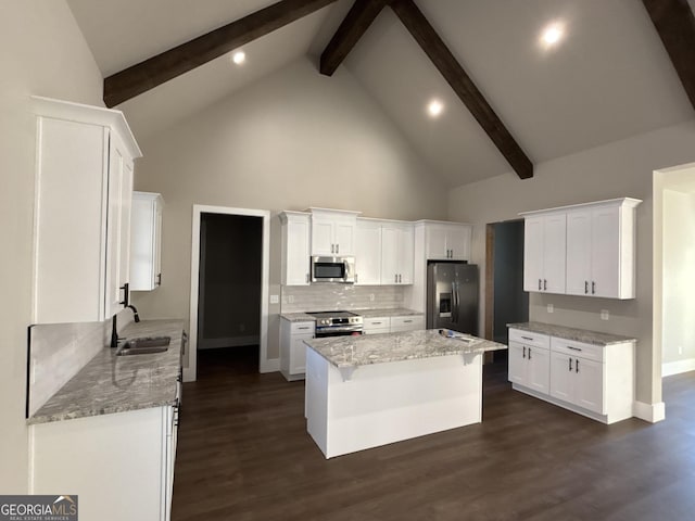 kitchen featuring white cabinets, dark hardwood / wood-style floors, beam ceiling, and stainless steel appliances