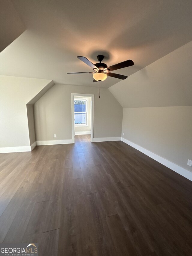 bonus room with ceiling fan, dark hardwood / wood-style flooring, and lofted ceiling