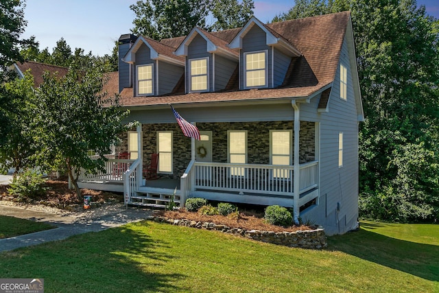 cape cod-style house with a front lawn and covered porch