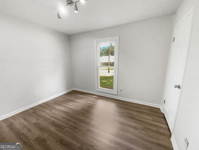 unfurnished bedroom featuring dark wood-style floors and baseboards