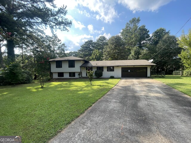 split level home featuring a front lawn and a garage