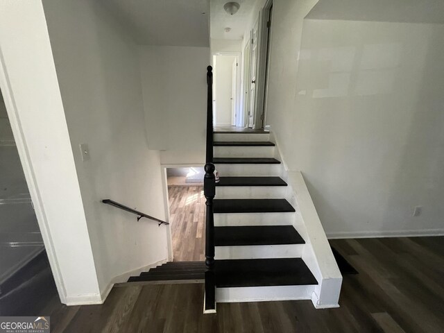 staircase featuring hardwood / wood-style flooring