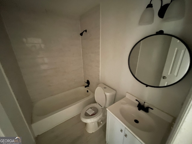 full bathroom featuring tiled shower / bath combo, toilet, and vanity