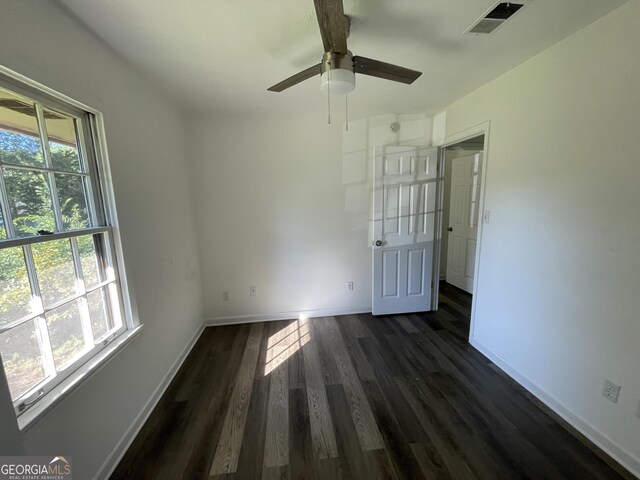 unfurnished bedroom with ceiling fan and dark hardwood / wood-style floors