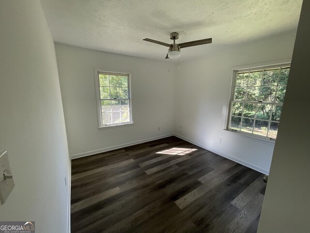 empty room with ceiling fan and wood-type flooring