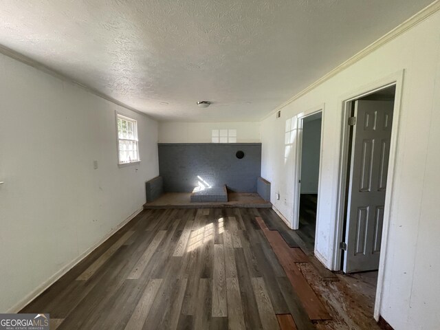 interior space with hardwood / wood-style flooring and a textured ceiling