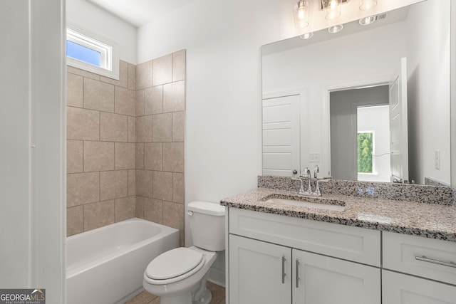 bathroom featuring toilet, shower / bath combination, and vanity