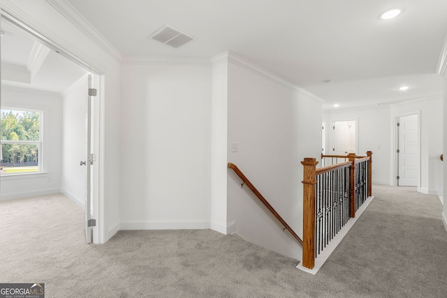 hallway with recessed lighting, light carpet, visible vents, an upstairs landing, and crown molding