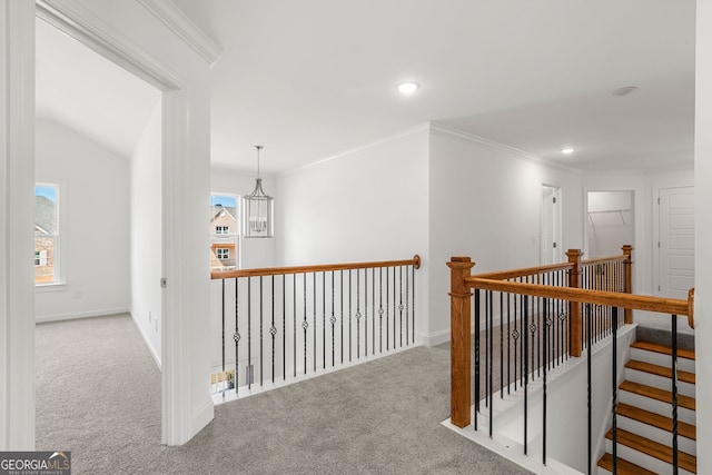 corridor with ornamental molding, recessed lighting, a healthy amount of sunlight, and light carpet