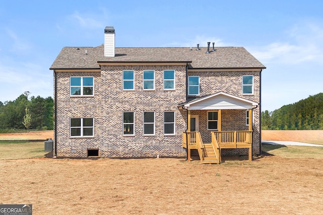 rear view of property with brick siding, a chimney, central AC unit, crawl space, and a deck