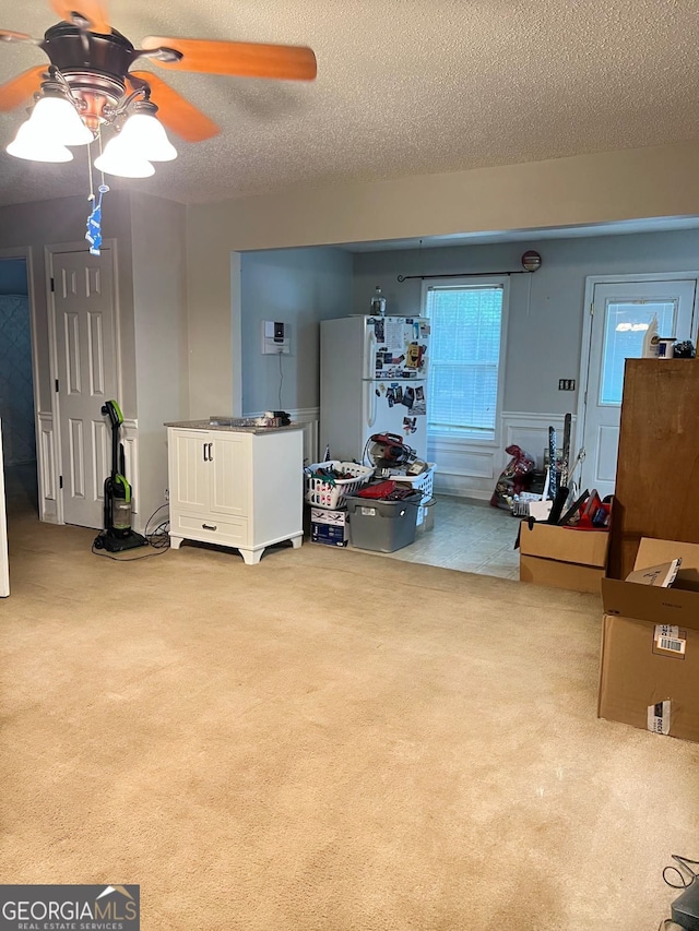 interior space featuring a textured ceiling and ceiling fan