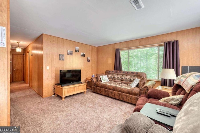 living room with wood walls and light carpet