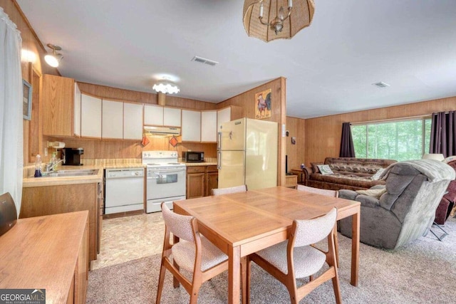 dining space with wooden walls and visible vents