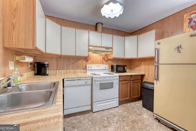 kitchen featuring white cabinets, a sink, light countertops, white appliances, and under cabinet range hood